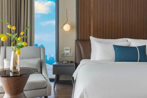 Voodi või voodid majutusasutuse Peninsula Hotel Danang toas