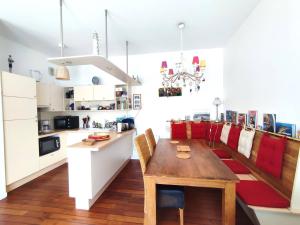 a kitchen and dining room with a wooden table at Duplex à 50m de la plage avec parking et 2 chambres - FR-1-368-391 in Trégastel +6 photos