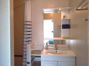 a bathroom with a sink and a mirror at Duplex à 50m de la plage avec parking et 2 chambres - FR-1-368-391 in Trégastel