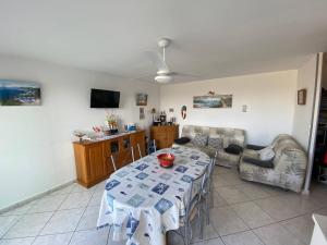 a living room with a table and a tv at T3 Moderne 6p au bord de la mer, Le Barcarès, parking et terrasse - FR-1-81-593 in Le Barcarès