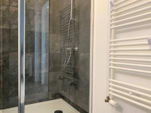 a shower with a glass door in a bathroom at Appartement neuf avec balcon, proche du port de Perros-Guirec - FR-1-368-392 in Perros-Guirec +10 photos