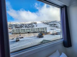 a window in a room with a view of a building at Lodge 21 in Perisher Valley