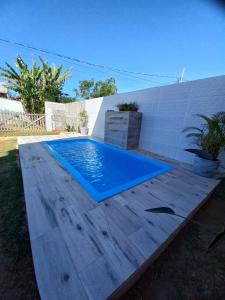 a swimming pool in a backyard with a blue swimming pool at Chalé Penedo Charmosa in Penedo