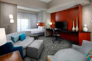 a hotel room with a bed and a desk at Courtyard by Marriott San Antonio Six Flags at The RIM in San Antonio