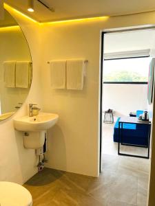 a bathroom with a sink and a mirror at Gomez House in Manila