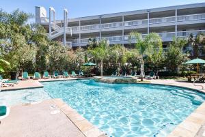 a large swimming pool with chairs and a building at Casa Del Mar 174-sea U Soon in Galveston