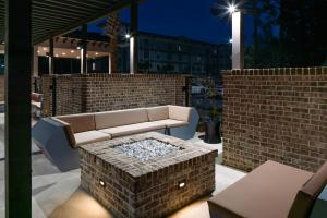 a patio with a couch and a brick wall at SpringHill Suites Hilton Head Island in Hilton Head Island