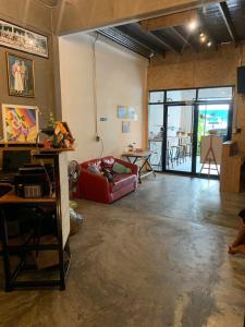 a living room with a couch and a table at Good Space Hostel in Khlong San