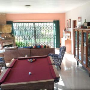 a living room with a pool table in it at Sítio Sapiranga in Sapiranga