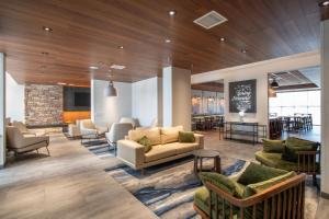 a lobby with couches and chairs and a chalkboard at Fairfield by Marriott Inn & Suites Newport Cincinnati in Newport