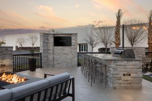 an outdoor patio with a bar and a fireplace at SpringHill Suites by Marriott Columbia near Fort Jackson in Columbia