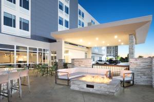an outdoor patio with a fire pit and tables and chairs at SpringHill Suites by Marriott Columbia near Fort Jackson in Columbia