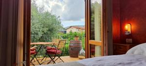 a bedroom with a view of a balcony with a table and chairs at ČEBRON FAMILY ESTATE in Branik