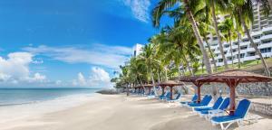 a row of chairs and umbrellas on a beach at Royal Cliff Grand Hotel Pattaya in Pattaya South +48 photos
