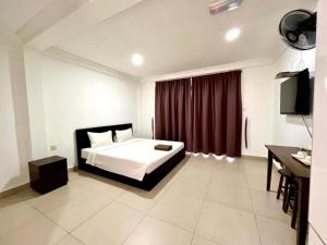 a bedroom with a bed and a red curtain at JR RESORT in Ranau