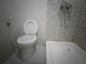a small bathroom with a toilet and a shower at Balqies Homestay Syariah Makassar Mitra RedDoorz in Makassar