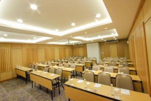 a large room with tables and chairs in it at Ivory Hotel Bandung in Bandung