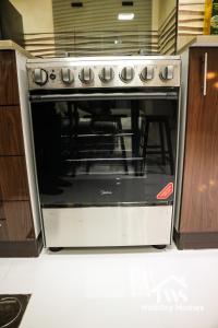 a oven in a kitchen with its door open at The Urban Oasis - Serenity in Dubai