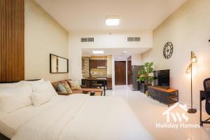 a bedroom with a large bed and a living room at The Urban Oasis - Serenity in Dubai