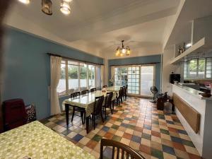 a kitchen and dining room with a table and chairs at Hualien Bay in Jian