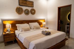 a bedroom with a large bed with two hats on it at Villa Innerbloom stylish 2BR with large pool & garden in Canggu