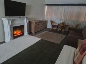 a living room with a fireplace and a couch at Prideau's of Margaret River in Margaret River Town