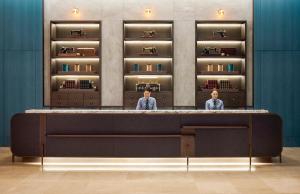 two people standing behind a counter in a room at Four Points by Sheraton Seoul, Guro in Seoul