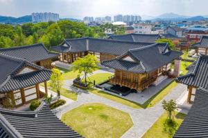 an overhead view of a building with black roofs at Hanok Stay Namwonyechon by Kensington in Namwon