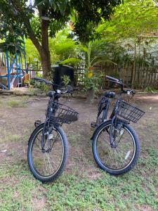 two bikes parked in the grass next to a park at Mustika Ocean Lodge in Gili Air