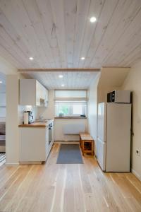 a kitchen with white cabinets and a refrigerator at Posti studio apartment in Paide