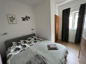 a bedroom with a bed and a window at Villa Marija in Crikvenica