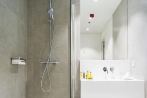 a shower with a glass door in a bathroom at Marriott Executive Apartments Brussels in Brussels +57 photos