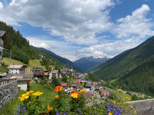a town in a valley with flowers on a hill at Hotel Garni Central - Zimmer - Studios - Apartments in Kappl