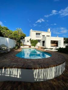 a house with a swimming pool in a yard at Audiophile Relax Hideaway on the Water in Cape Town