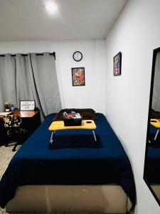 a bedroom with a bed with a table on it at Habitación Roma in Mexico City