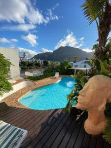 a large swimming pool sitting next to a house at Audiophile Relax Hideaway on the Water in Cape Town