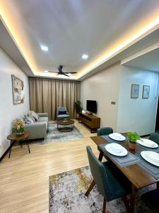 a living room with a table and a couch at Modern Stylish Apartment (Seaview) near KTCC Mall. in Kuala Terengganu