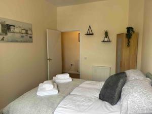 a bedroom with a bed with towels on it at 7A Murray Street in Duns