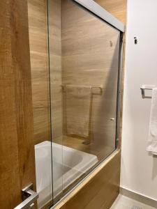 a shower with a glass door in a bathroom at Camino al Mar in Mazatlán