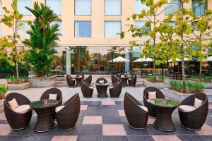 a courtyard with chairs and tables in a building at Courtyard by Marriott Kochi Airport in Nedumbassery