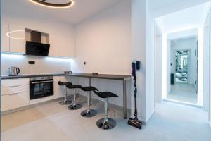 a kitchen with a counter and stools at SithoniaRS Luxury 1st Floor Apartment With SeaView in Neos Marmaras