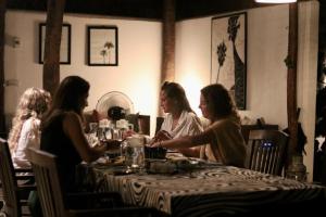 three women sitting at a table in a restaurant at Anawasal in Kalpitiya
