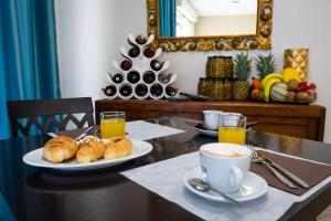 a table with two plates of pastries and a cup of coffee at La Dimora Del Re in Bitritto