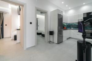 a kitchen with white cabinets and a sink at SithoniaRS Luxury 2nd Floor Roofgarden Apartment With Unique Seaview in Neos Marmaras