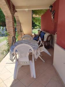 a white table and chairs on a patio at Villa Patty in Pian di Mulino