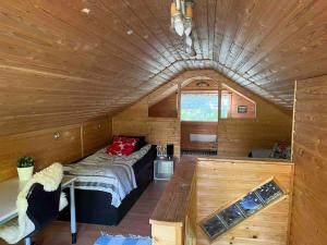 a large room with a bed in a wooden cabin at Casa Aura in Aura