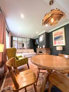 a living room with a table and a couch at Magnolia Cottage - Kent in Lyminge +18 photos