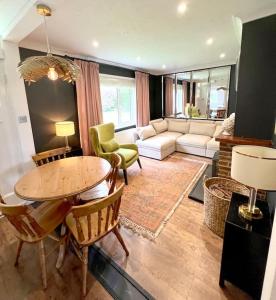 a living room with a table and a couch at Magnolia Cottage - Kent in Lyminge