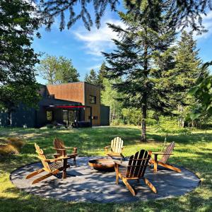 a group of chairs and tables in a park at **** Le Patio **** aux portes de Chambord in Crouy-sur-Cosson