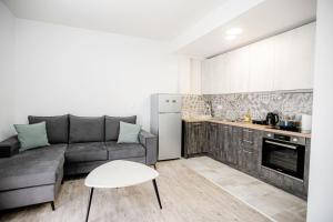 a living room with a couch and a kitchen at John luxury apartment in Alexandroupoli
